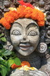 Carved stone statue with flower decoration
