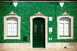 Old house with green tiles on facade