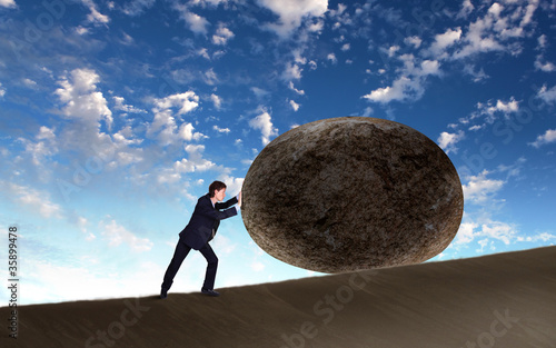 Illustration: Businessman rolling a giant stone Businessman rolling a giant stone