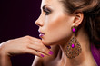 elegant fashionable woman with violet jewelry