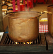 traditional preparation of  spanish meal in a copper ancient pan