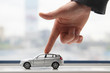 The finger moves the toy car
