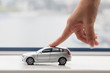 The finger moves the toy car