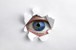 Looking through a hole in white paper
