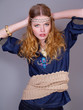 Foto: beautiful woman dressed in folklore style with a knitted belt beautiful woman dressed in folklore style with a knitted belt