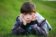 Foto: Boy lies on a grass Boy lies on a grass