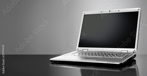 Photo: Modern laptop isolated on black background Modern laptop isolated on black background