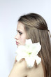 girl with a lily looking in a distance