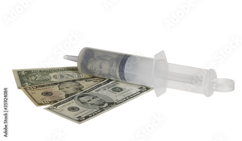 Photo: plastic syringe and dollar banknotes plastic syringe and dollar banknotes