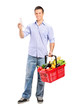 Man looking at store receipt and holding a shopping basket