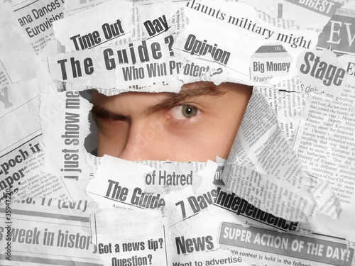 Photo: Sceptic look through the newspapers Sceptic look through the newspapers