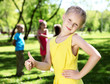 Foto: Little girl in summer park with friends Little girl in summer park with friends