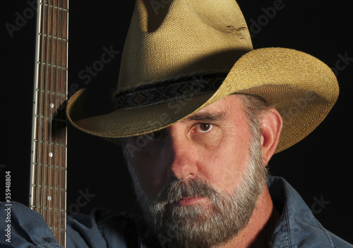 Photo: A Cowboy with a Gray Beard and a Guitar A Cowboy with a Gray Beard and a Guitar