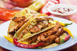Taco shells filled with chicken meat Taco shells filled with chicken meat