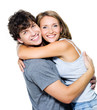 Smiling young couple embracing - isolated