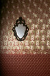 Vintage mirror on the  luxury wall with wallpaper