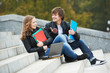 Two smiling young students outdoors