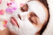 Young woman with cosmetic mask on her face.