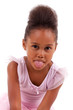 Cute little African Asian girl sticking tongue out Cute little African Asian girl sticking tongue out