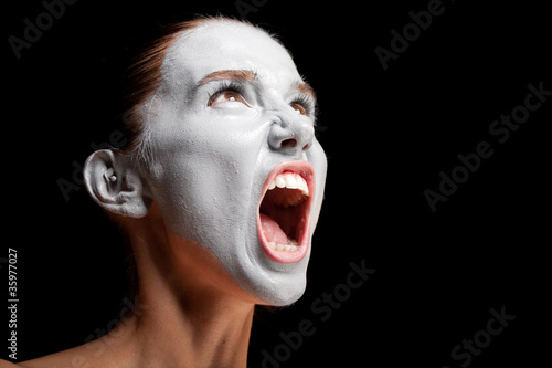 Photo: Mime girl looks up and screams. Mime girl looks up and screams.