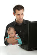 Father working on laptop while babysitting