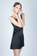 Young asian fashion woman posing in studio in black dress