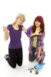 Two young joyful girls draw with motley paints