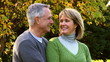 Happy elderly senior couple in park