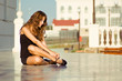 Woman fastening sandals Woman fastening sandals