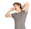 Photo: standing young tired man yawning and stretching standing young tired man yawning and stretching
