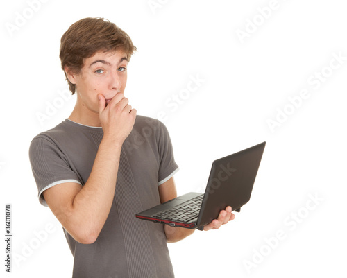 Photo: young man working on laptop, white background young man working on laptop, white background