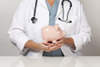 Doctor with Stethoscope Holding Piggy Bank Abstract Doctor with Stethoscope Holding Piggy Bank Abstract