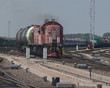 Train carrying oil in the tanks approaches and passes.