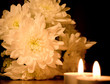 Photo: Beautiful white floweres and two burning candles Beautiful white floweres and two burning candles
