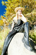 fisher woman sitting on stone