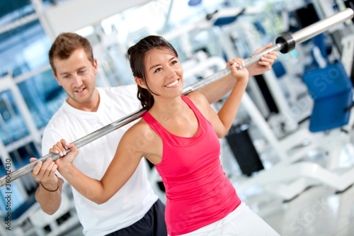 Photo: Gym woman with her trainer Gym woman with her trainer