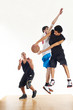 Three basketball players