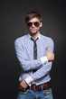 Fashion handsome man posing over black background