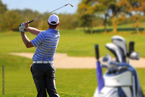Photo: Man playing golf with golf bag Man playing golf with golf bag