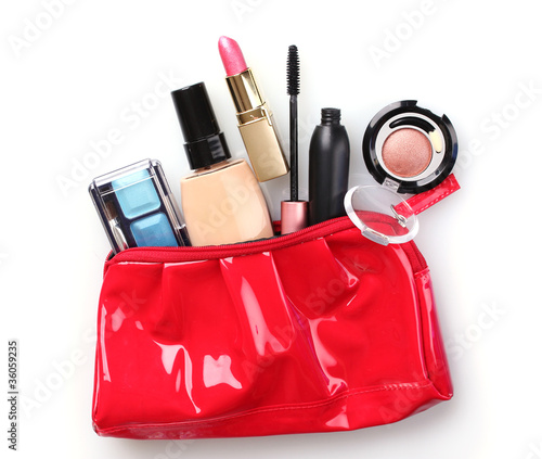 Photo: Beautiful red makeup bag and cosmetics isolated on white Beautiful red makeup bag and cosmetics isolated on white
