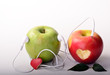 Green apple with headphone and red apple with heart