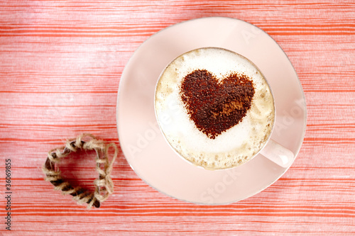 Photo: cappuccino with heart, red stripy backdrop cappuccino with heart, red stripy backdrop