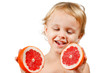 Little boy with a pink grapefruit on a white background