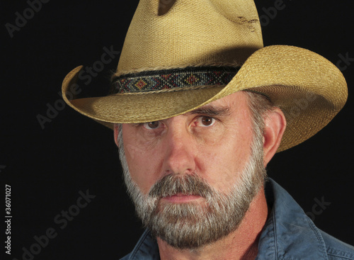 Photo: A Man with a Gray Beard in a Straw Cowboy Hat A Man with a Gray Beard in a Straw Cowboy Hat