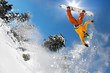Snowboarder jumping against blue sky