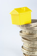 Small model house and coins