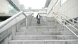 Man running down stairs in town Man running down stairs in town