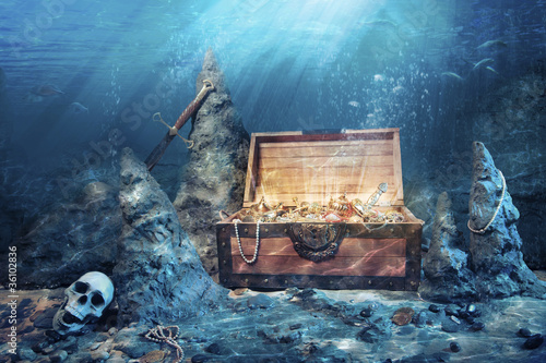 Photo: open treasure chest with bright gold underwater open treasure chest with bright gold underwater