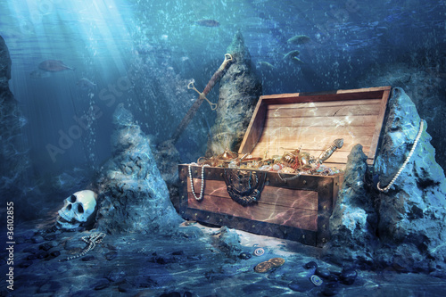 Photo: open treasure chest with bright gold underwater open treasure chest with bright gold underwater