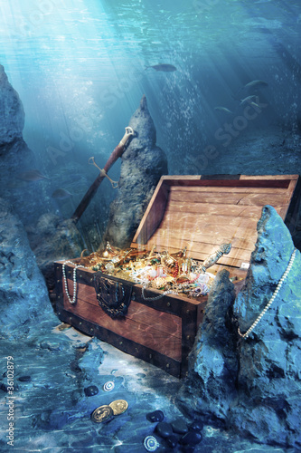 Photo: open treasure chest with bright gold underwater open treasure chest with bright gold underwater
